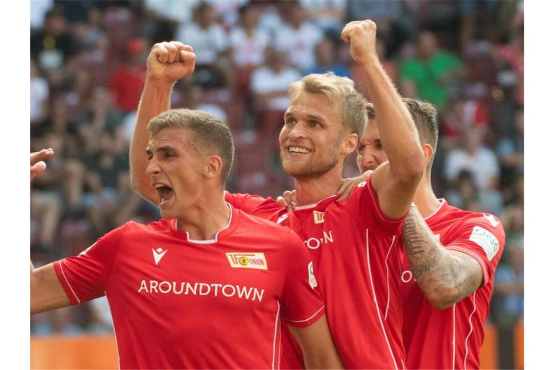 Grischa Prömel (l-r), Sebastian Andersson und Robert Andrich feiern das erste Union-Tor der Bundesliga-Geschichte. Foto: Stefan Puchner