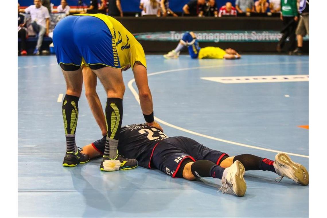 Gummersbachs Marvin Sommer tröstet nach Spielende Bietigheims Jan Asmuth. Beide Teams sind abgestiegen. Foto: Christoph Schmidt