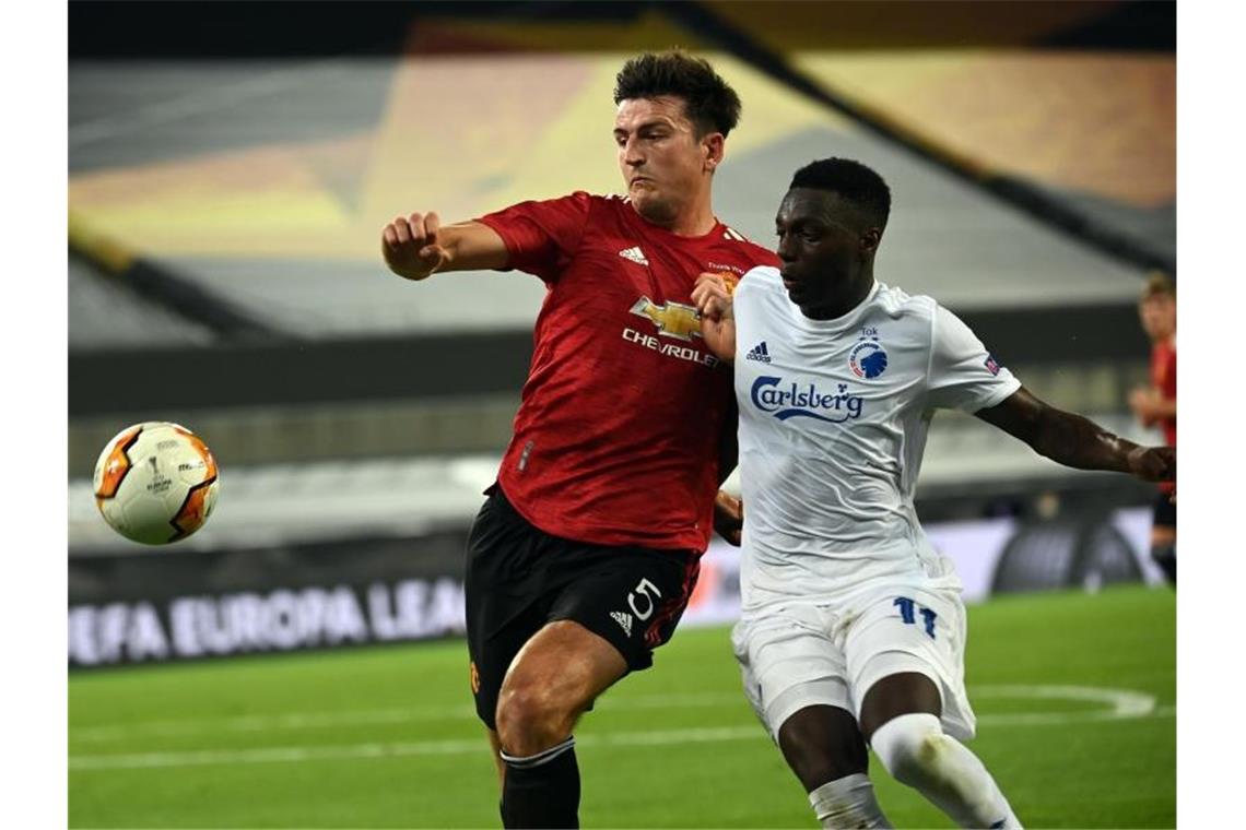 Manchester United mit Mühe ins Europa-League-Halbfinale Harry Maguire (l) im Zweikampf mit dem Kopenhagener Mohamed Daramy. Foto: Federico Gambarini/dpa