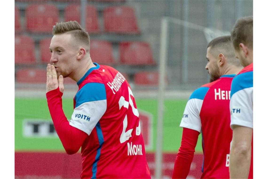 Heidenheims Tobias Mohr (l) schickt ein "Küsschen" Richtung Tribüne nach seinem Treffer zum 2:1. Foto: Stefan Puchner/dpa