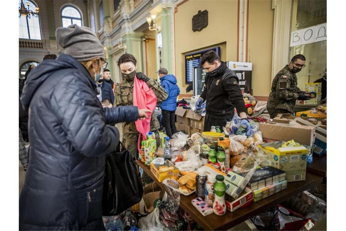 EU will Regeln für „Massenzustrom“ Vertriebener nutzen Helfer verteilen Lebensmittel und Süßigkeiten an Geflüchtete am Bahnhof von Przemysl. Foto: Michael Kappeler/dpa