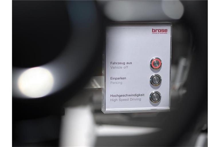 Hinter einem Lenkrad des Automobilzulieferers Brose ist eine Schalttafel aufgestellt. Foto: David-Wolfgang Ebener/dpa