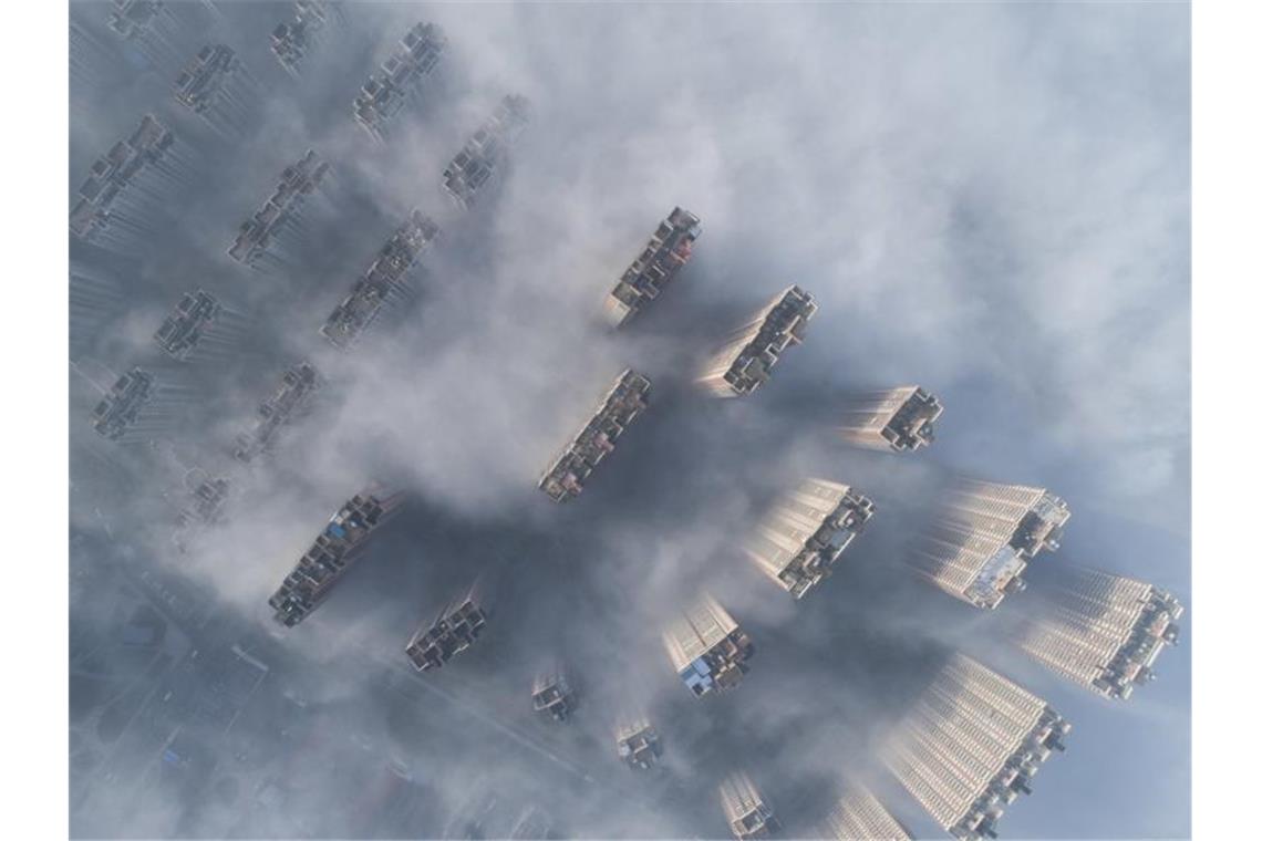 Treibhausgasausstoß steigt wieder Hochhäuser im chinesischen Nanton ragen aus dem Smog heraus. Foto: Xu Jingbo/SIPA/ZUMA/dpa