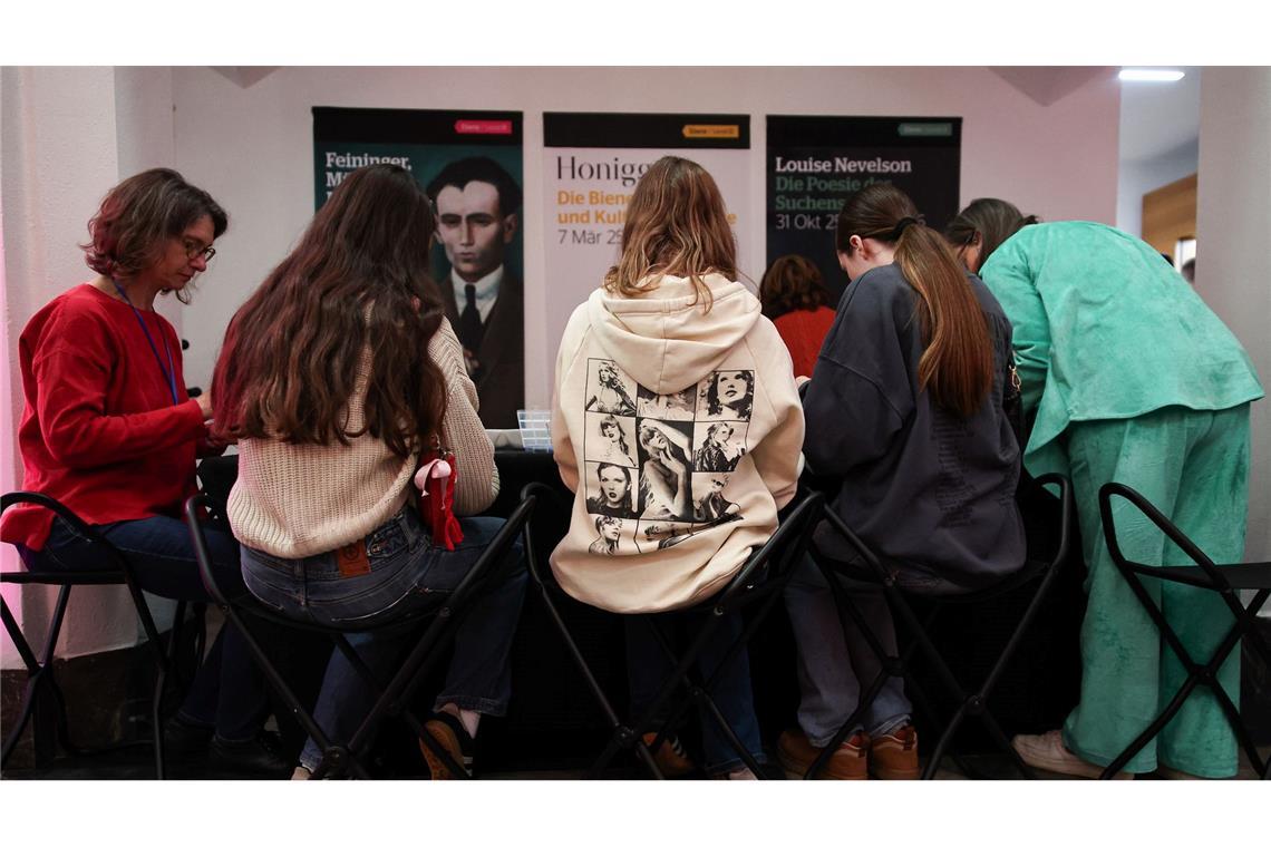 Im Foyer des Museums läuft Popmusik, während Fans Freundschaftsbändchen knüpfen.