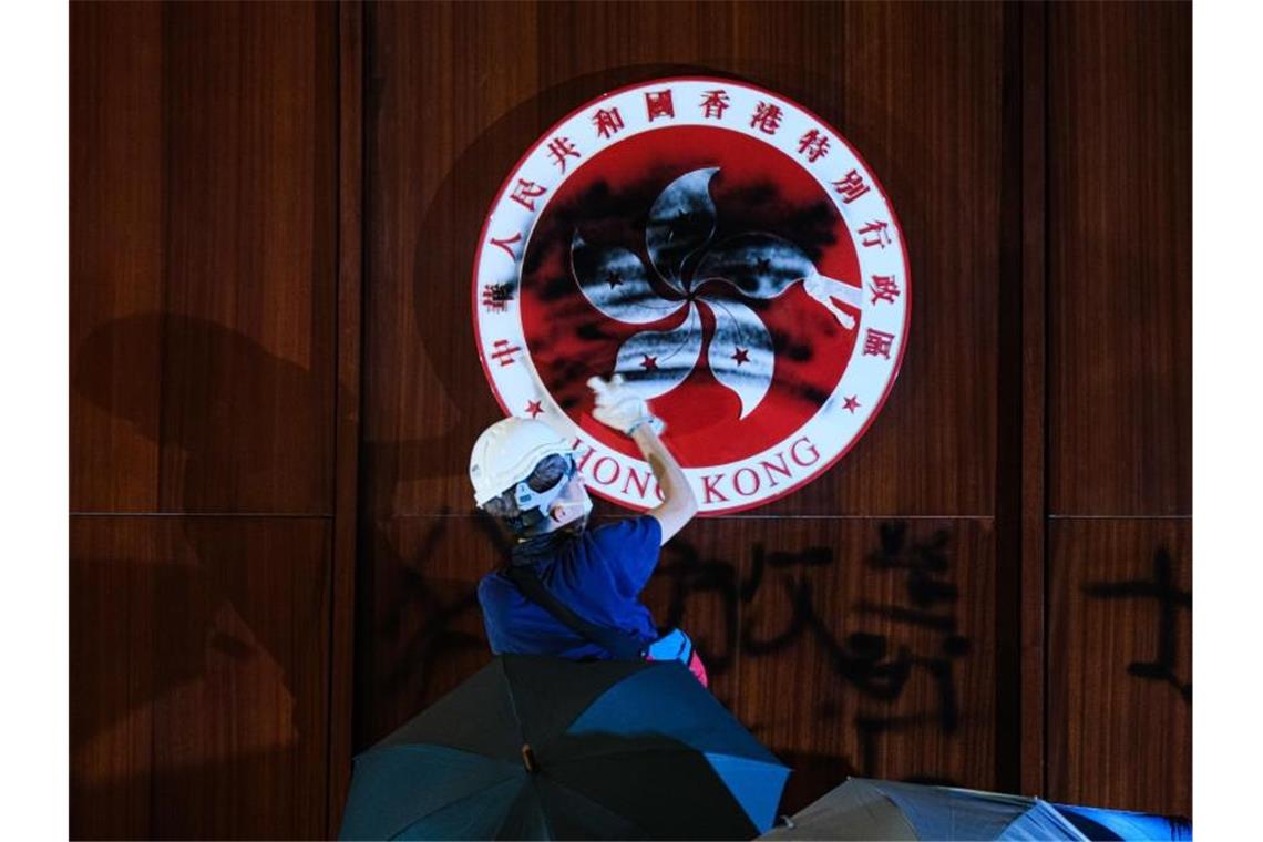 Im Hongkonger Parlament, dem Gebäude des Legislativrats, schwärzt ein Demonstrant das Emblem der Stadt. Foto: Keith Tsuji/ZUMA Wire