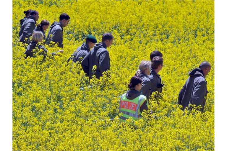 Im Juni 2010 durchsuchen Polizisten bei Heidenheim ein Rapsfeld nach Spuren im Fall Bögerl. Foto: picture alliance / dpa