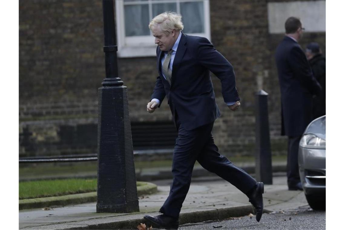 Im Laufschritt: Boris Johnson ist nach seiner Rückkehr aus dem Buckingham Palace auf dem Weg zurück in die 10 Downing Street. Foto: Matt Dunham/AP/dpa