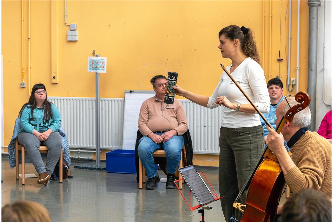 Im Workshop zeigen Markus Tillier (am Cello) und Jasmin Bachmann (Zweite von rechts) vom SWR-Symphonieorchester den Teilnehmenden, welche Instrumente im Orchester gespielt werden. Foto: Alexander Becher