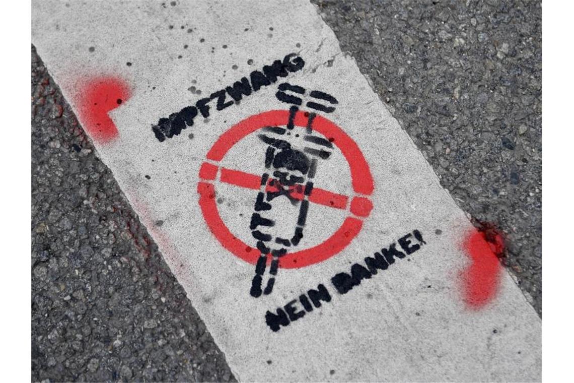 Tausende Teilnehmer bei Protesten gegen Corona-Maßnahmen „Impfzwang - Nein Danke!“ ist bei den Protesten in München auf eine Straße gemalt worden. Foto: Angelika Warmuth/dpa