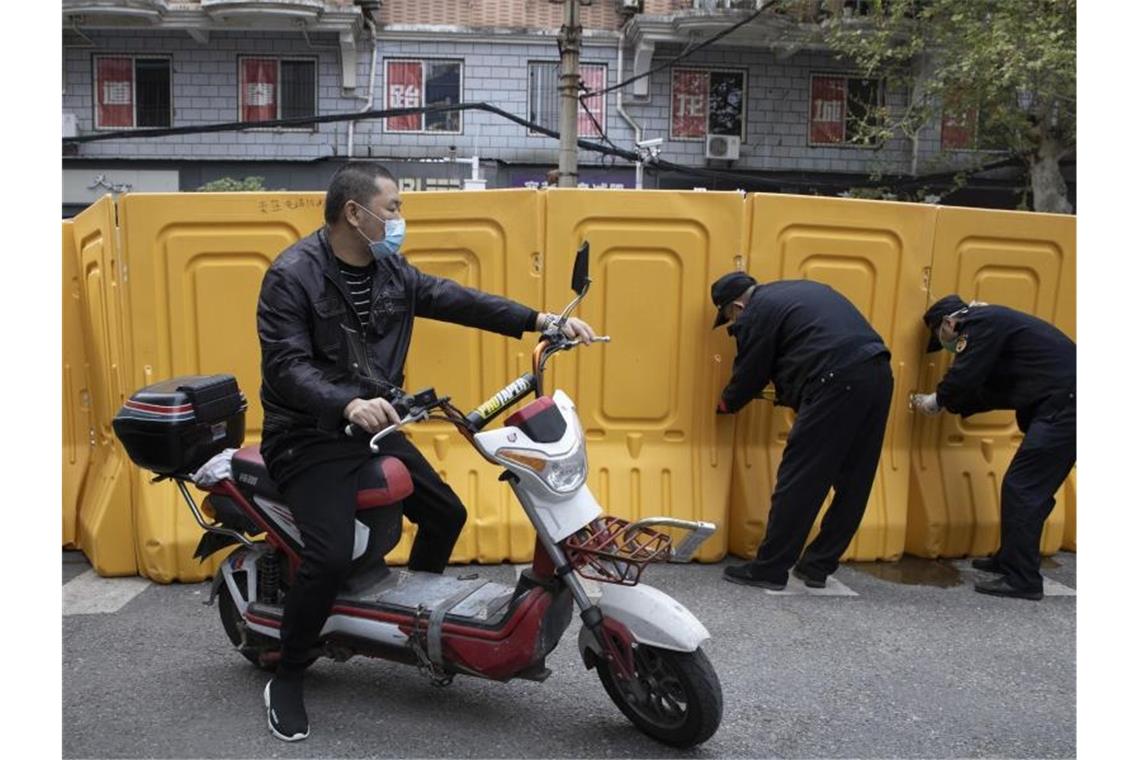 In der Stadt Wuhan werden Barrieren entfernt. Weil China offiziell kaum Neuinfektionen mit dem Coronavirus meldet, hebt es die Beschränkungen für die Bevölkerung allmählich auf. Foto: Ng Han Guan/AP/dpa