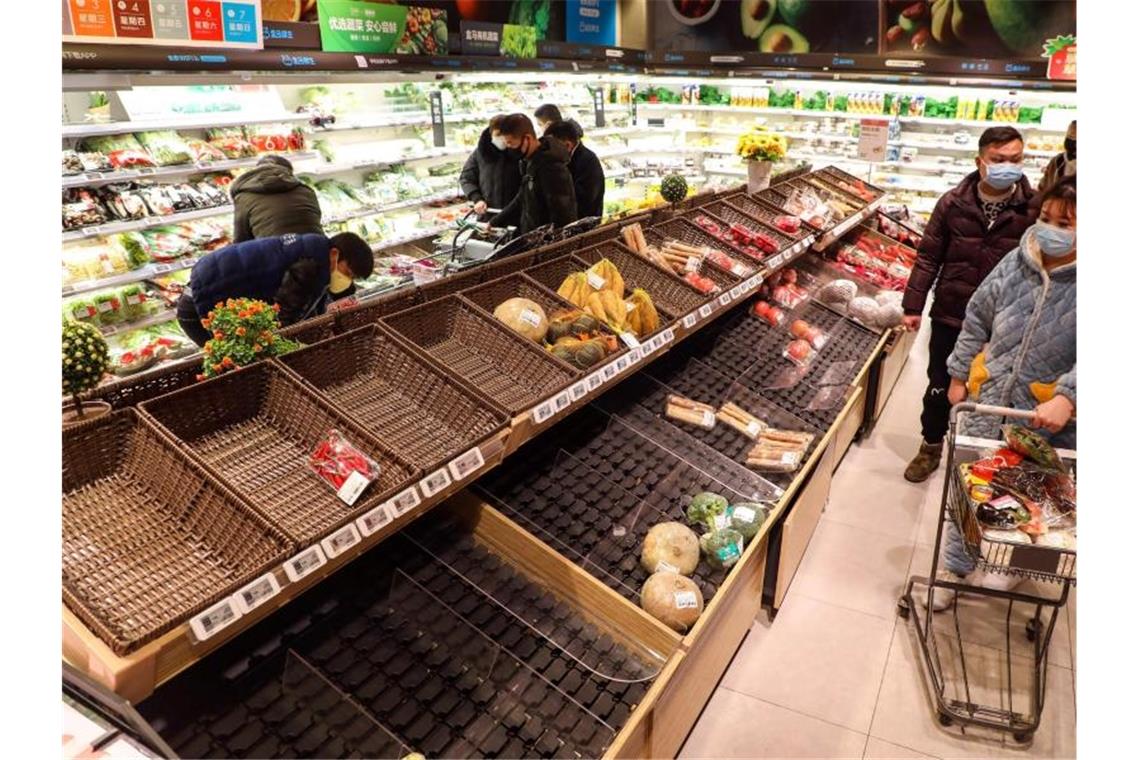 Immer mehr Infektionen: Berlin warnt vor Reisen nach China In diesem Supermarkt in Wuhan sind die Regale fast leer. Foto: CHINATOPIX/dpa