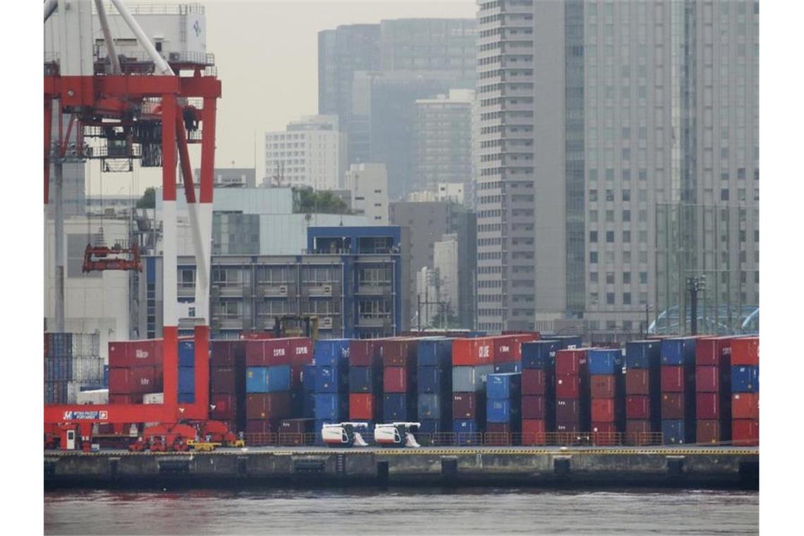 Japan schnürt weiteres milliardenschweres Konjunkturpaket In einem Hafen in Tokio werden Container gestapelt. Foto: Koji Sasahara/AP/dpa