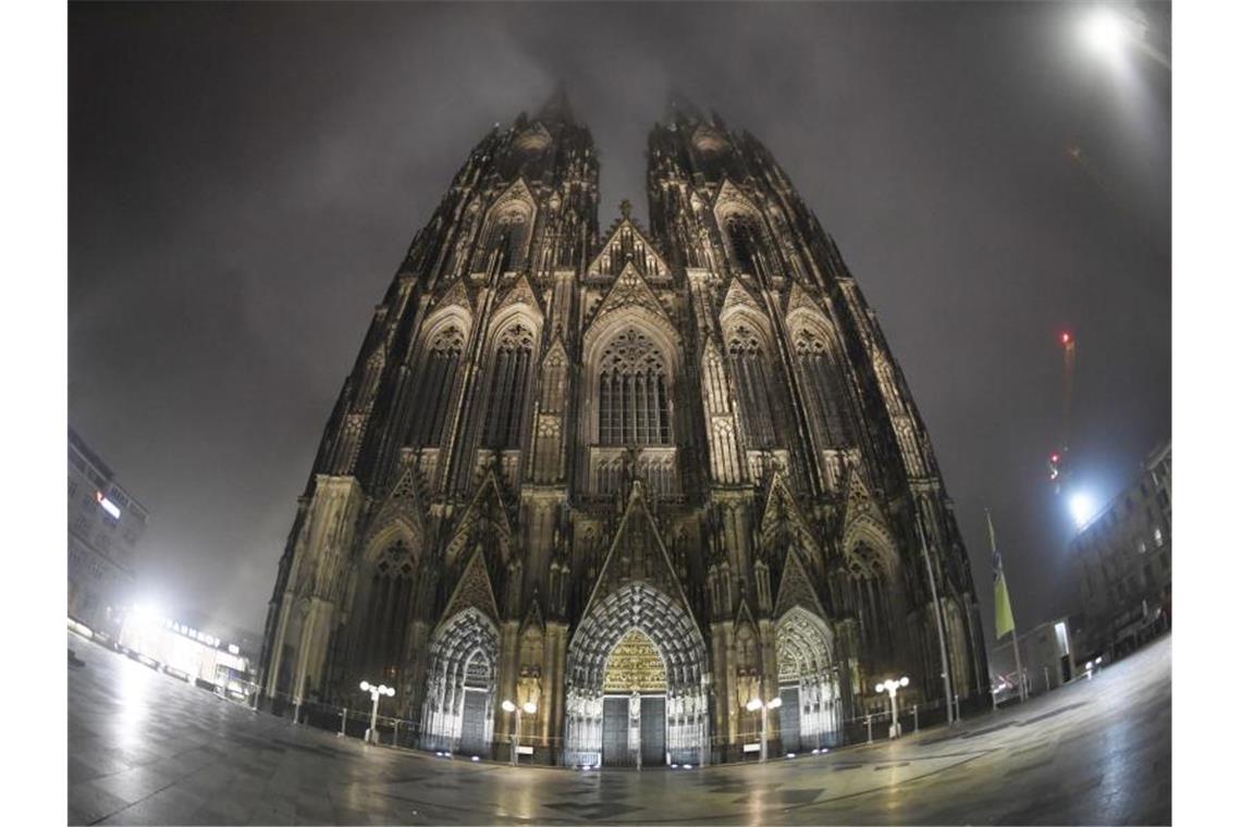 In Nebel eingehüllt ist der Dom nach den Feiern zum Karnevalsauftakt des Jahres bei dem mehrere tausend Menschen die närrische Jahreszeit starteten. Foto: Roberto Pfeil/dpa