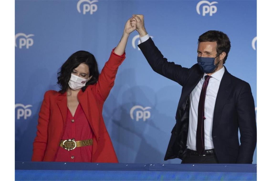 Isabel Diaz Ayuso (l) und Pablo Casado von der konservativen Volkspartei feiern ihren Wahlsieg. Foto: Bernat Armangue/AP/dpa