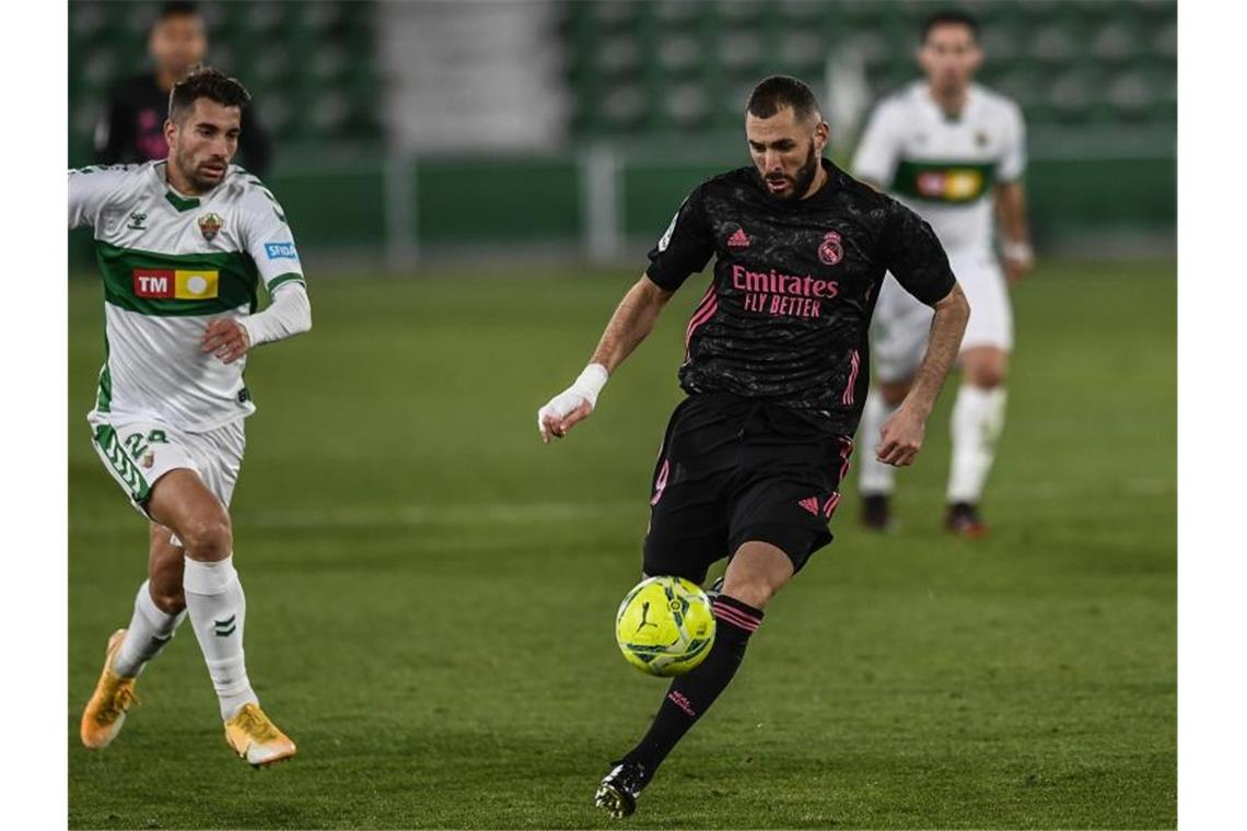 Josema (l) vom FC Elche gegen Karim Benzema von Real Madrid. Foto: Jose Breton/AP/dpa