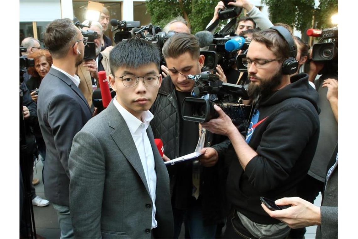 Joshua Wong wird nach seiner Pressekonferenz in Berlin von Medienvertretern umringt. Foto: Wolfgang Kumm