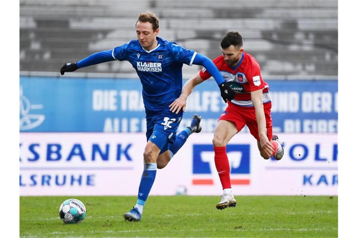 Spiel gedreht: HSV sichert sich Hinrundenmeisterschaft Karlsruhes Robin Bormuth (l) und Heidenheims Denis Thomalla teilten sich mit ihren Teams die Punkte. Foto: Uli Deck/dpa