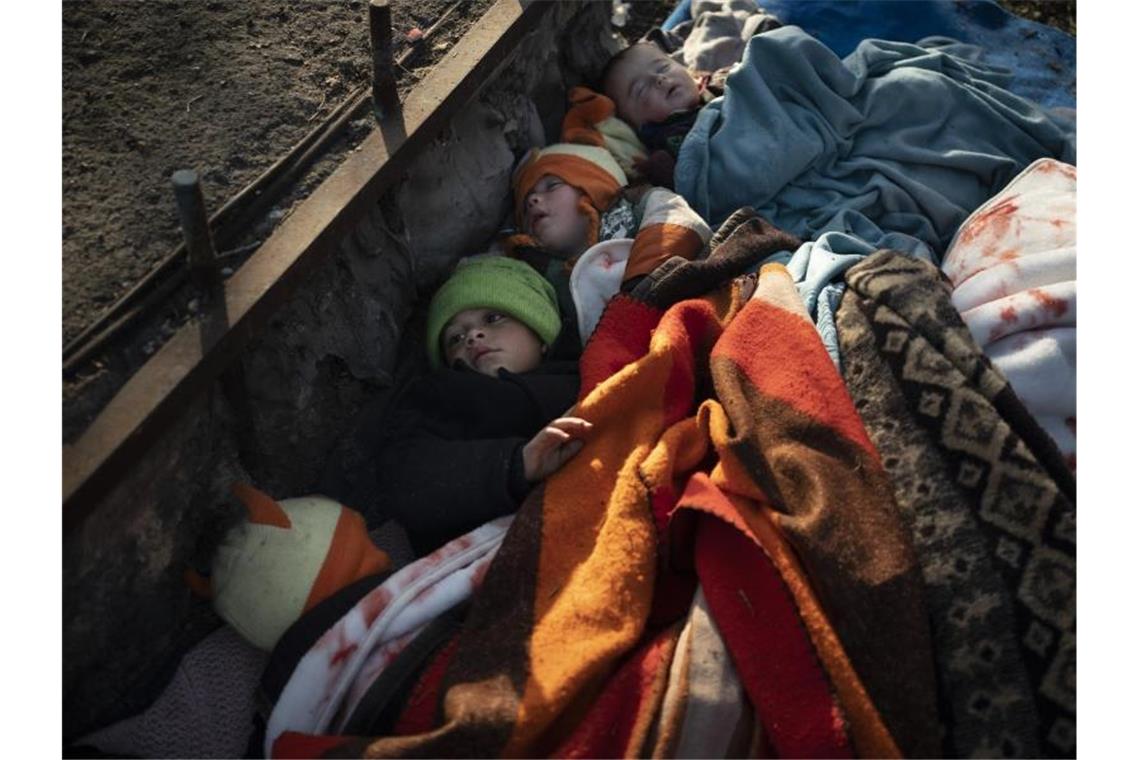 Kinder aus Syrien schlafen an einem Busbahnhof nahe der türkisch-griechischen Grenze. Foto: Felipe Dana/AP/dpa