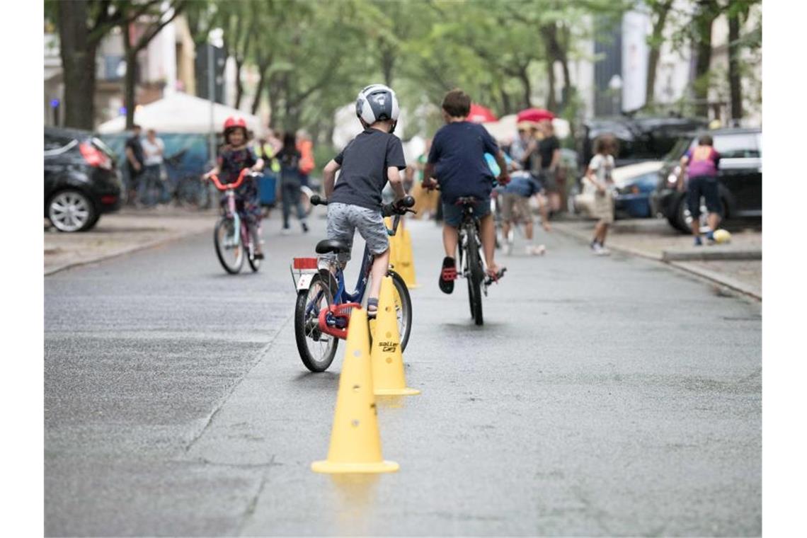 Temporäre Spielstraßen sind selten: Stuttgart ist Vorreiter Kinder fahren Fahrrad. Foto: Jörg Carstensen/Archivbild