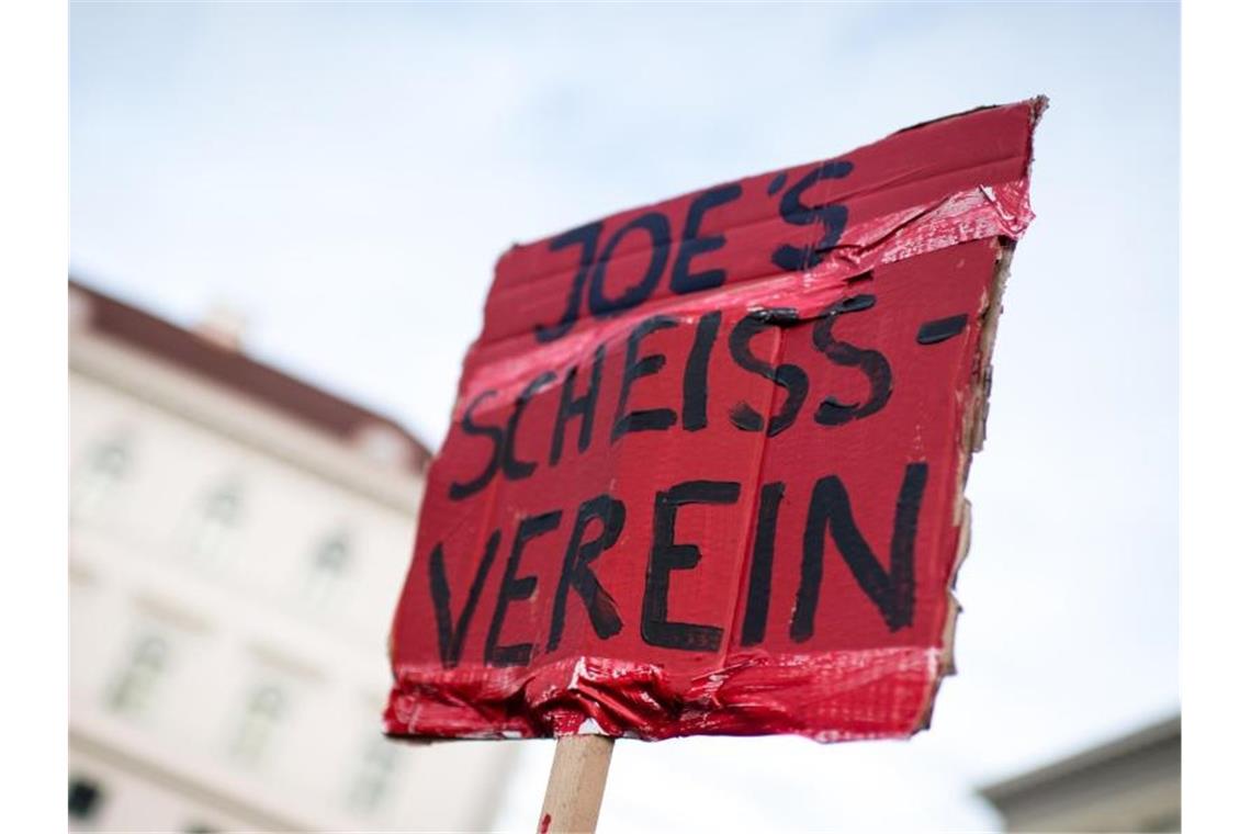 Klare Worte: Ein Demonstrant hält während einer Protestaktion von Fridays for Future vor der Siemens-Zentrale ein Schild mit der Aufschrift „Joe's Scheiss-Verein“. Foto: Matthias Balk/dpa
