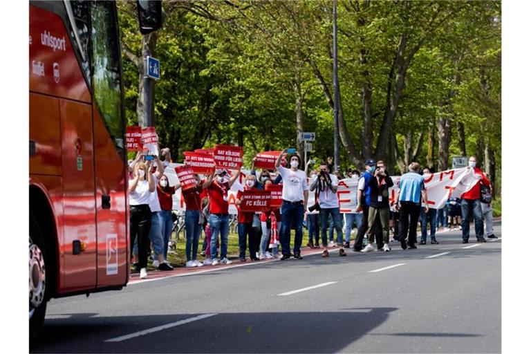 Kölner Fans feuern die Spieler bei der Ankunft im Mannschaftsbus an. Foto: Rolf Vennenbernd/dpa