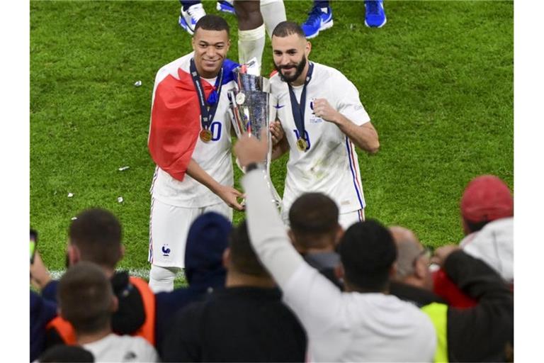 Kylian Mbappé (l) und Karim Benzema feiern den Gewinn der Nations League. Foto: Miguel Medina/Pool AFP via AP/dpa
