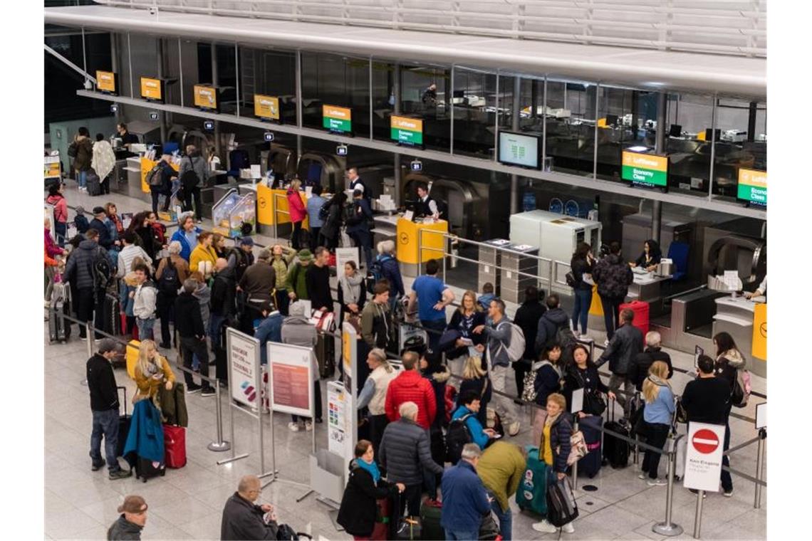 Lange Schlangen vor den Lufthansa-Schaltern am Münchner Flughafen. Foto: Matthias Balk/dpa