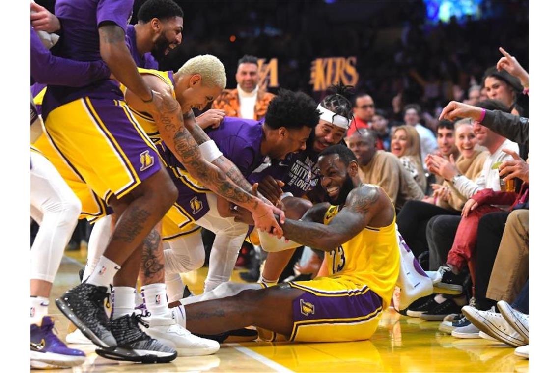 LeBron James (sitzend) wird nach mehreren erfolgreichen Drei-Punkte-Würfen für die Lakers von seinen Mitspielern bejubelt. Foto: Mark J. Terrill/AP/dpa