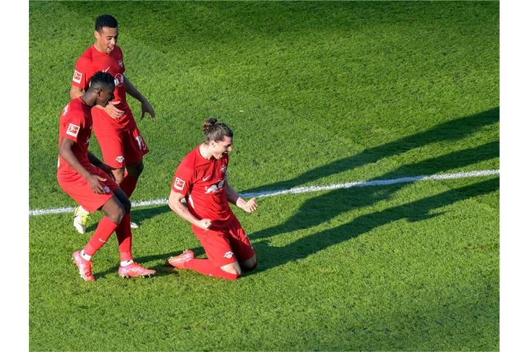 Leipzigs Torschütze Marcel Sabitzer (r) jubelt mit den Mannschaftskameraden Amadou Haidara (l) und Tyler Adams über seinen Treffer zur 1:0-Führung. Foto: Soeren Stache/dpa POOL/dpa