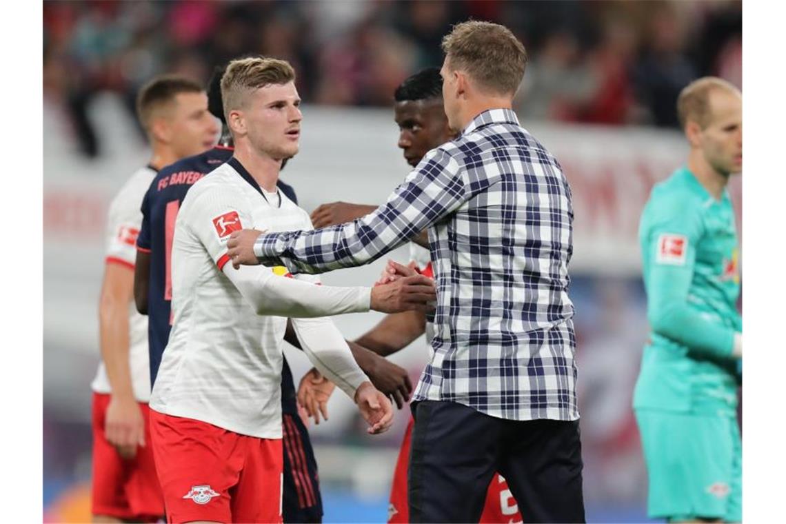 Leipzigs Werner (l) und Trainer Nagelsmann (M) klatschen sich nach dem Unentschieden gegen den FC Bayern München ab. Foto: J. Woitas