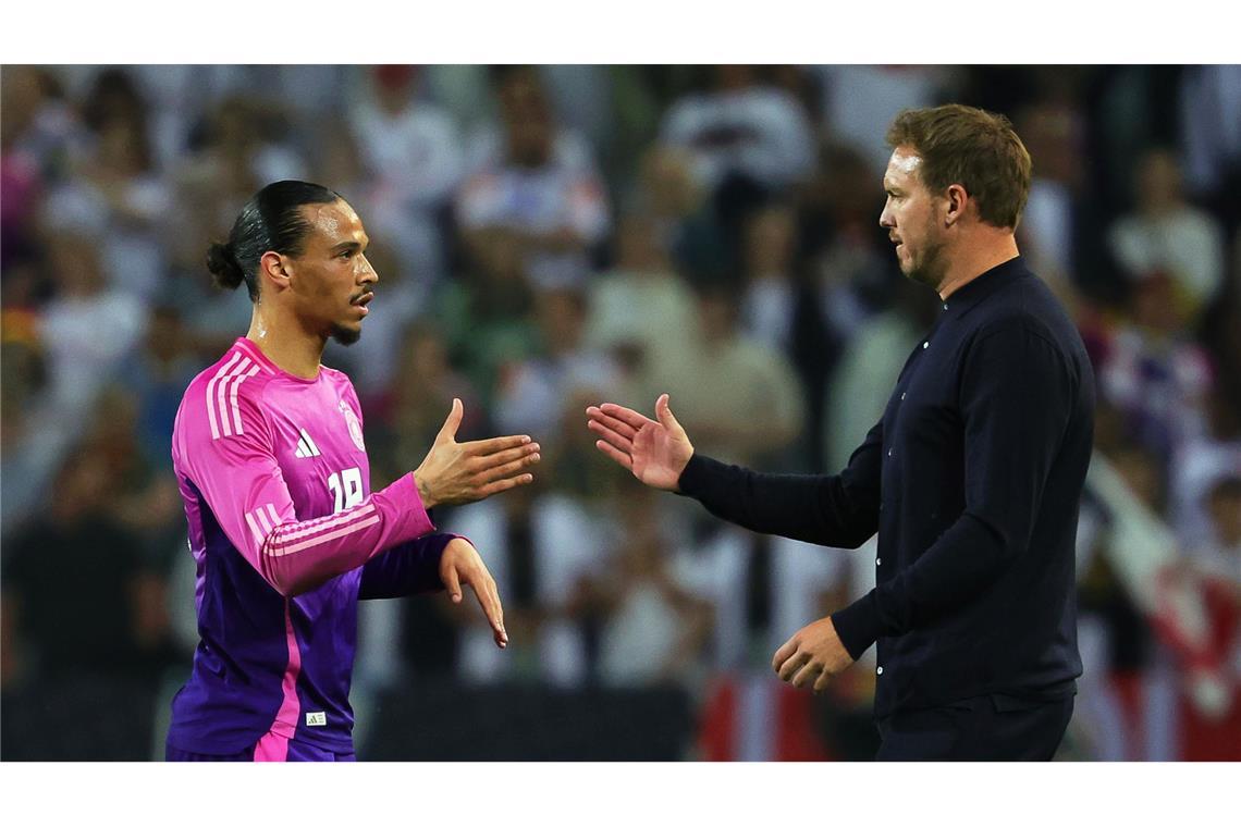 Leroy Sané (l) und Julian Nagelsmann klatschen nach einem Spiel ab. (Archivbild)