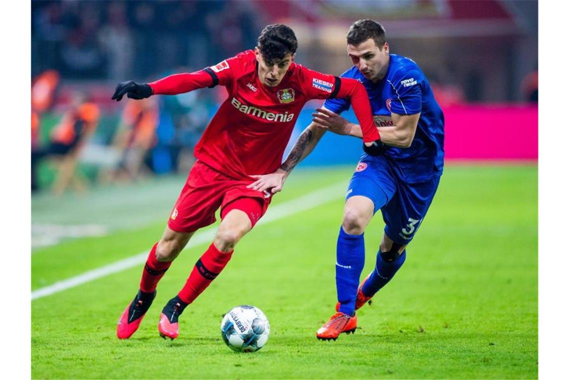 Leverkusens Kai Havertz (l) im Zweikampf mit Düsseldorfs Marcel Sobottka. Foto: Rolf Vennenbernd/dpa