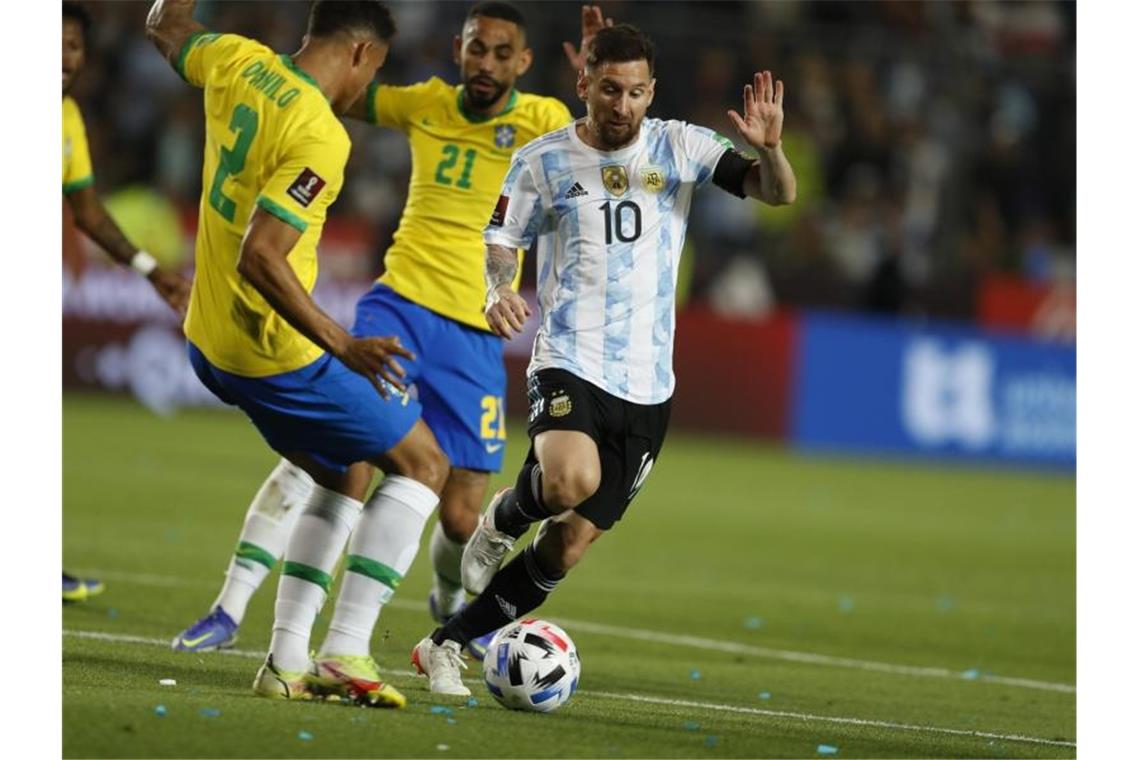 Lionel Messi (r) aus Argentinien in Aktion gegen Matheus Cunha (hinten) und Danilo (l) aus Brasilien. Foto: Gustavo Ortiz/dpa