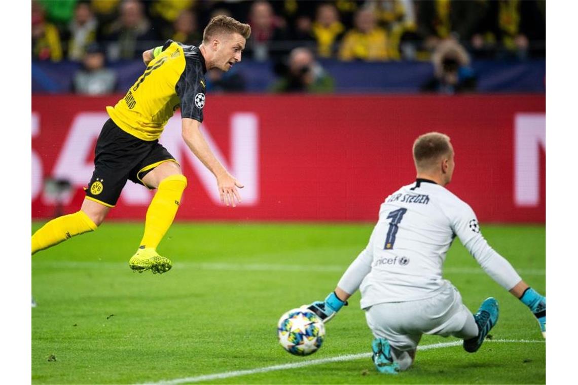 Marco Reus (l) scheitert mit seinem Schuss an Barcelonas Torhüter Marc-Andre ter Stegen. Foto: Marius Becker