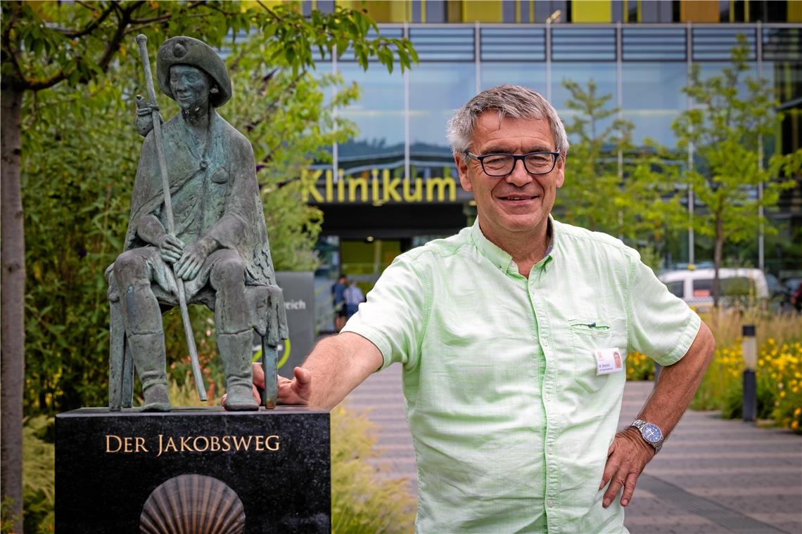 Martin Stierand ist gern auf Pilgerreisen unterwegs, ob vor Ort oder in fremden Ländern. Dieser persönlichen Tradition wird er treu bleiben. Insofern gesellt er sich gern zur Jakobswegskulptur, die sich auf dem Areal des Klinikums Winnenden befindet. Der 65-Jährige pflegt übrigens auch den Abschnitt des Jakobswegs von dort bis Obermühle. Foto: Alexander Becher