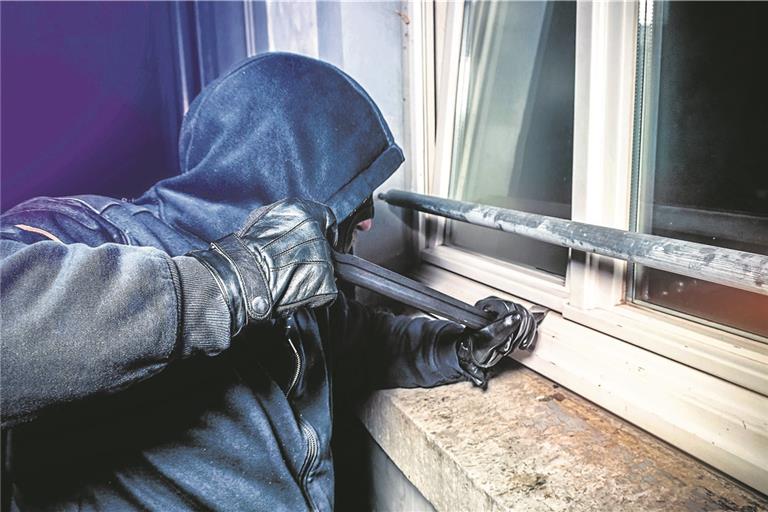 masked burglar with crowbar breaking and entering into a victim’s home - shot with dramatic motion