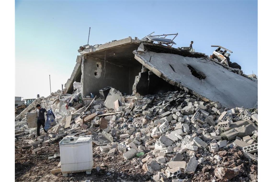 Menschen retten Brauchbares aus den Trümmern eines Gebäudes, das durch nächtliche Luftangriffe auf Wohngebiete in der Provinz Idlib zerstört wurde. Foto: Anas Alkharboutli