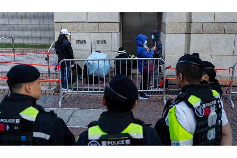 Menschen warten vor dem West Kowloon Magistrates' Courts auf die Urteilsverkündung gegen den Hongkonger Aktivisten und Verleger Jimmy Lai.