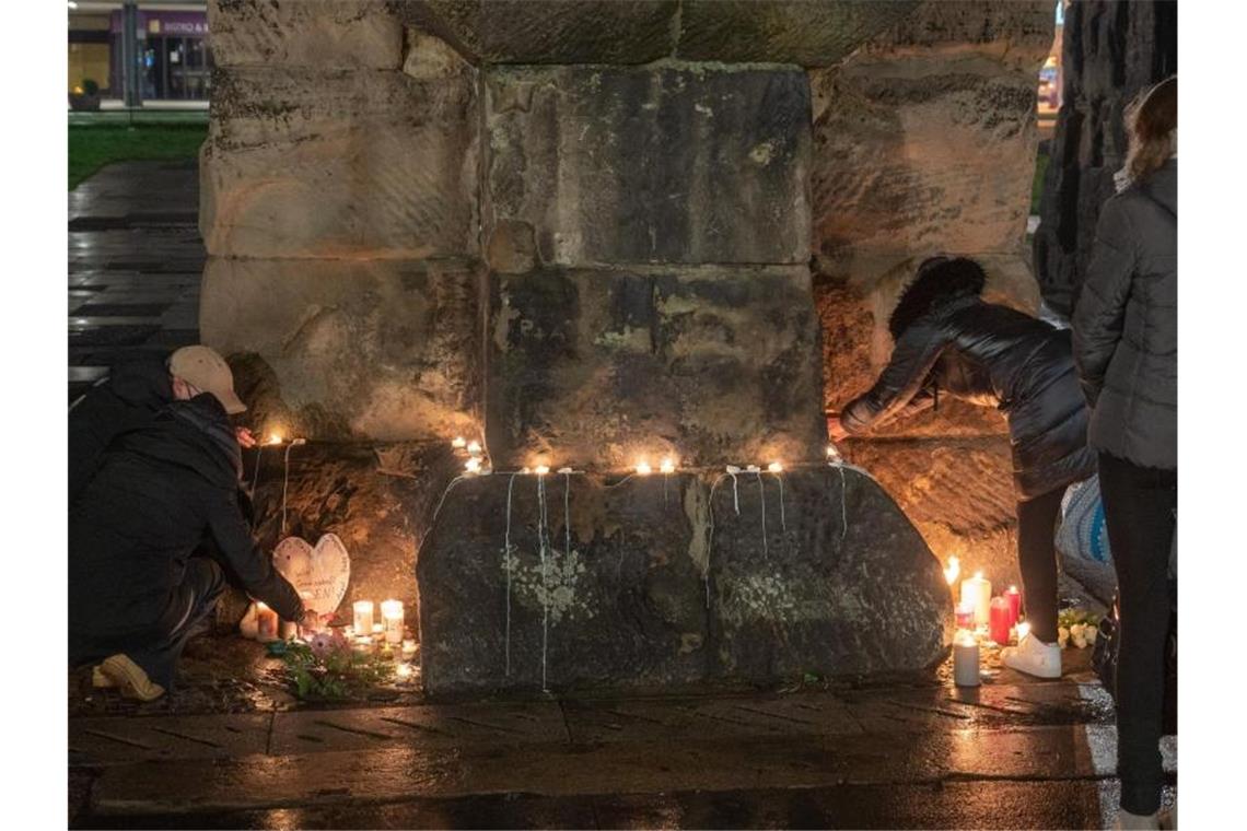 Menschen zünden an der Porta Nigra in Trier Kerzen für die Opfer der Amokfahrt an. Foto: Harald Tittel/dpa