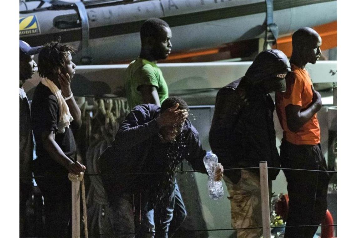 Migranten gehen von Bord eines italienischen Polizeiboots der Guardia di Finanza. Foto: Francesco Ruta/ANSA
