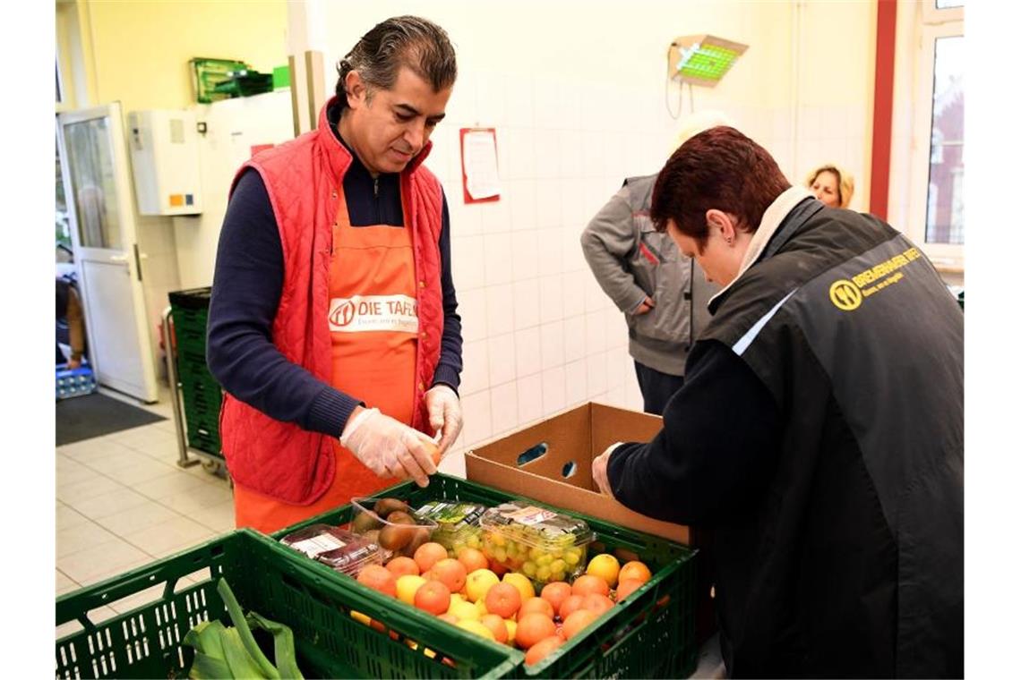 Mitarbeiter der Bremerhavener Tafel bereiten Obst und Gemüse vor. In keiner Stadt bundesweit leben so viele überschuldete Menschen wie in Bremerhaven. Foto: Carmen Jaspersen