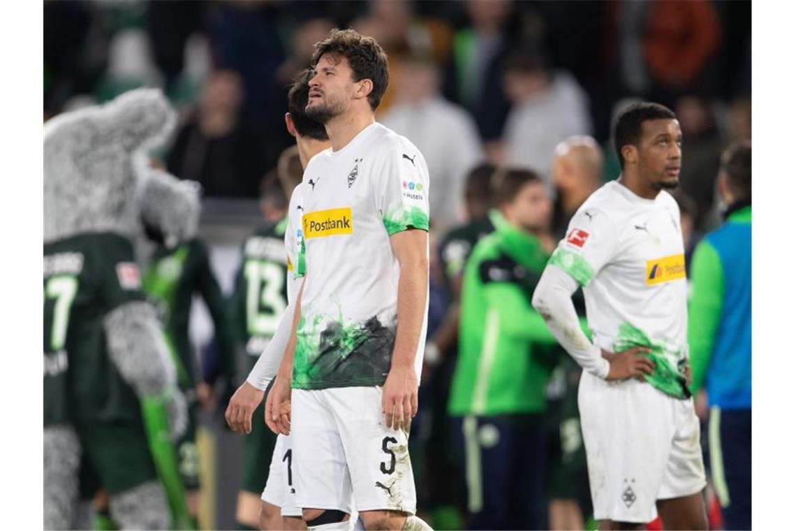 Gladbach fühlt sich „wie ein Punchingball“ Mönchengladbachs Spieler stehen nach der bitteren Niederlage in Wolfsburg enttäuscht auf dem Platz. Foto: Swen Pförtner