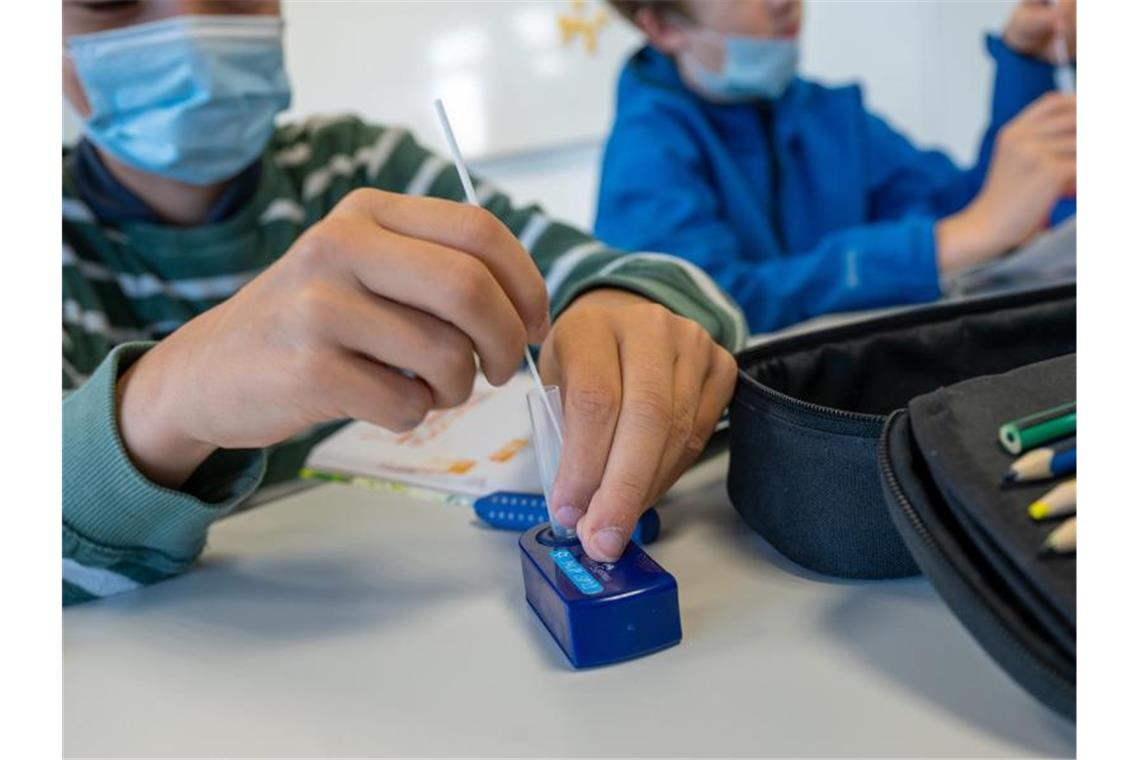 Münchner Schüler machen zu Beginn des Unterrichts einen Covid-19-Schnelltest. Die 7-Tage-Inzidenz in Deutschland ist am vierten Tag in Folge etwas gestiegen. Foto: Peter Kneffel/dpa