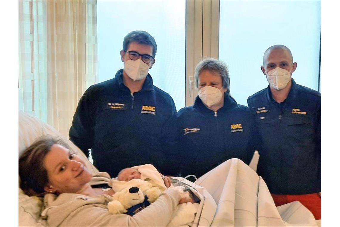 Mutter Sonja Lammers liegt mit Baby Martin Timotheus auf der Geburtsstation der Klinik Osnabrück. Dahinter stehen die "fliegenden Geburtshelfer" vom ADAC. Foto: ADAC Luftrettung/dpa