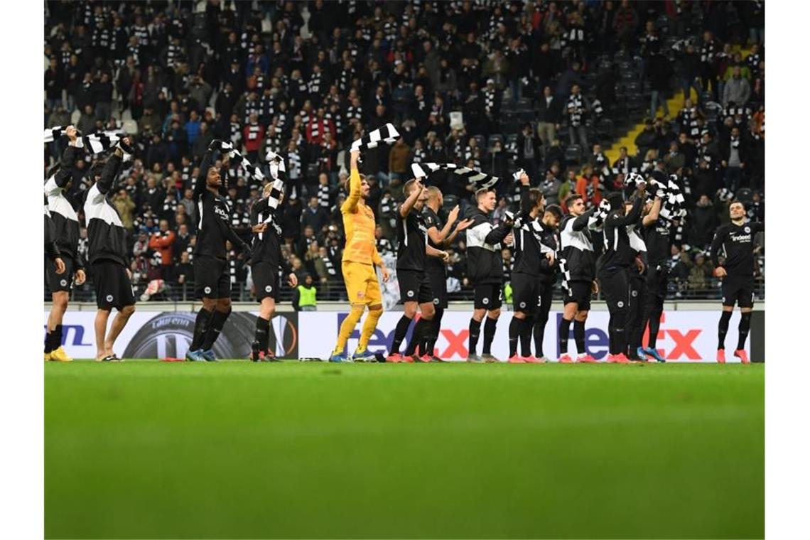 Nach dem 4:1-Sieg über RB Salzburg feiern die Spieler von Eintracht Frankfurt mit den Fans. Foto: Arne Dedert/dpa