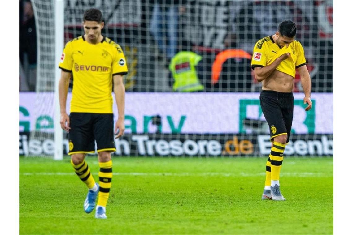 Nach dem Tor zur 4:3-Führung für Leverkusen ist Dortmunds Emre Can (r) die Freude über sein Traumtor zuvor vergangen. Foto: Guido Kirchner/dpa