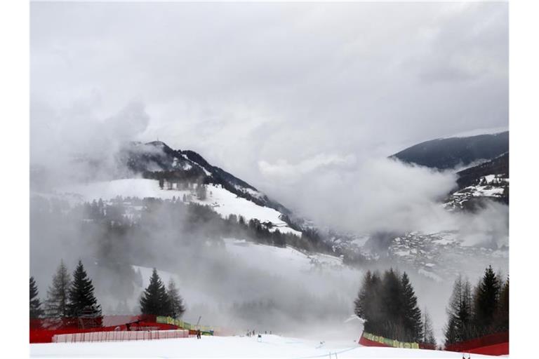 Nebel zieht in Gröden über die Berge und die Abfahrtsstrecke. Foto: Gabriele Facciotti/AP/dpa