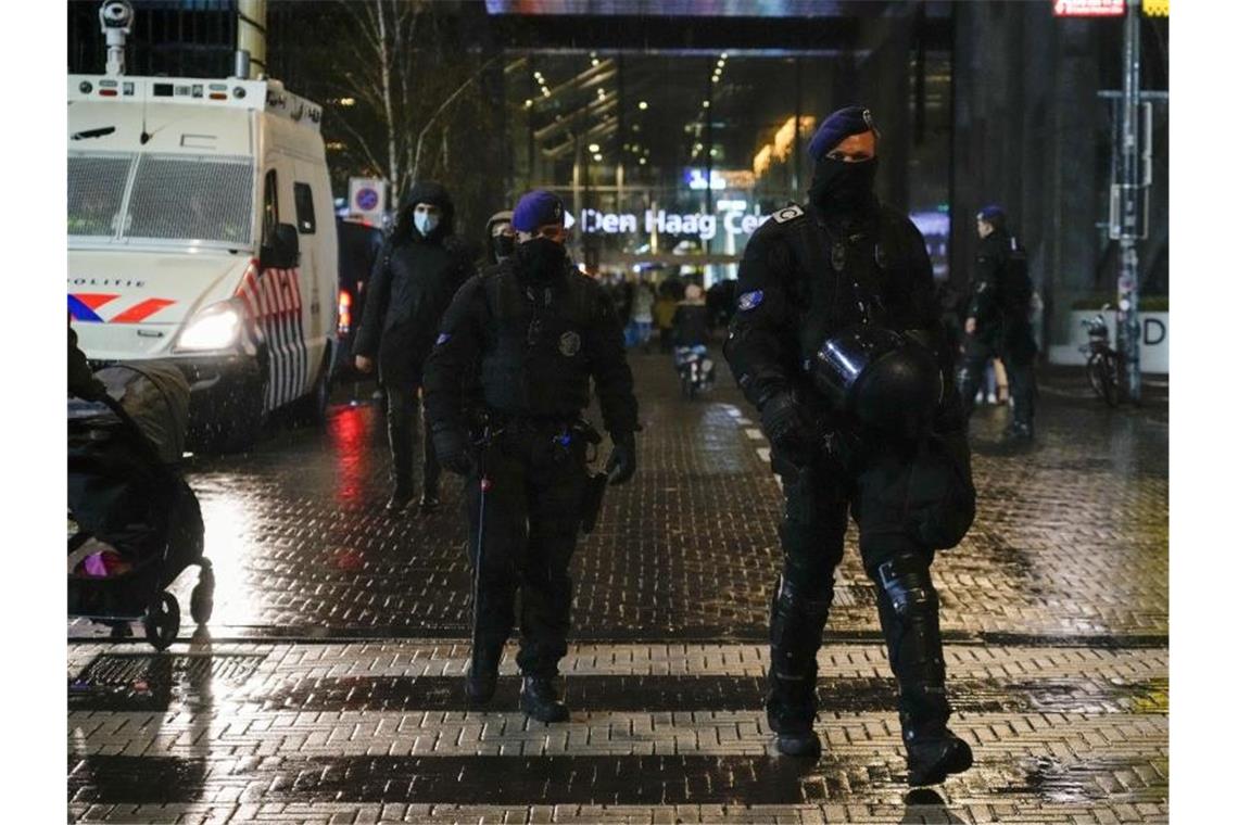 Niederländische Polizisten patrouillieren vor einem Ministeriumsgebäude. Foto: Peter Dejong/AP/dpa