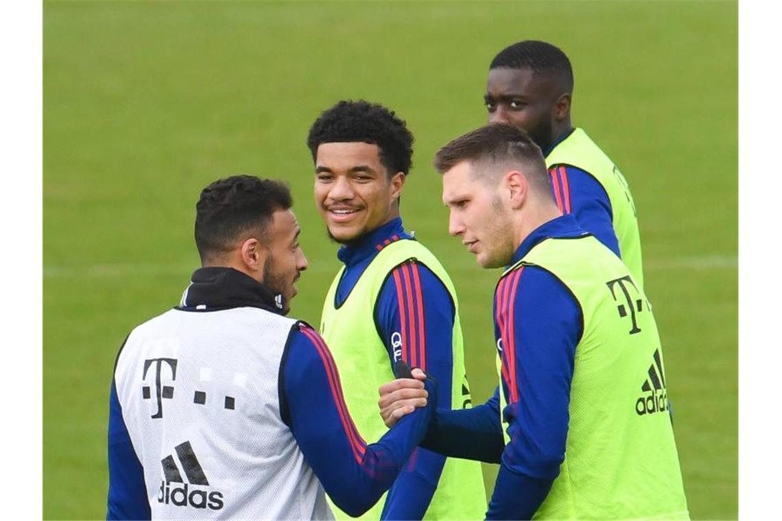 „Kein sportlicher Aufstieg“: Verwunderung über Süle Niklas Süle (vorne, r) klatscht mit Corentin Tolisso beim Training des FC Bayern München ab. Foto: Tobias Hase/dpa