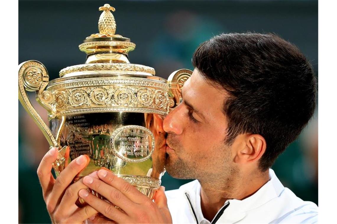 Novak Djokovic küsst bei der Siegerehrung die Trophäe für den Finalgewinner. Foto: Mike Egerton/PA Wire